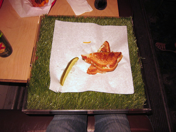  Grill Cheese served on a pitch of grass.
